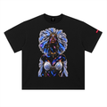 A black short-sleeve crewneck t-shirt featuring a large, vibrant cosmic graphic print of a woman with a voluminous blue and white afro hairstyle, set against a plain white background.